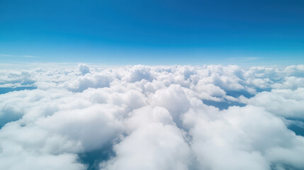 Fluffy white clouds blanket sky, creating serene and tranquil atmosphere