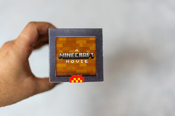 Fototapeta premium Bangkok, Thailand - April 10, 2025 : Holding a blind box toy from McDonald's collaboration with Minecraft movie limited edition.