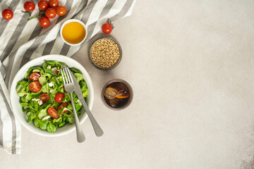 Tomato and mozzarella salad with pine nuts and fork.
