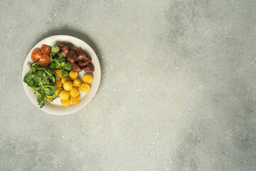 Vegetarian salad with mozzarella, pine nuts and tomatoes.