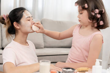 Happy children makeup for mother. Girl applying makeup. Activity family, Advertisement, lifestyle , cosmetics, makeup accessories, beauty activity, beautician, talent, love beauty