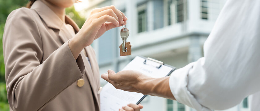 lease, rental and selling home. Real estate agent hold key for new house or real estate. rent house, Sales, loan credit financial, insurance, Seller, dealer, installment,  buy, sell, move in.