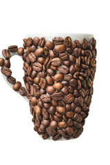 coffee cup covered in roasted coffee beans on white background