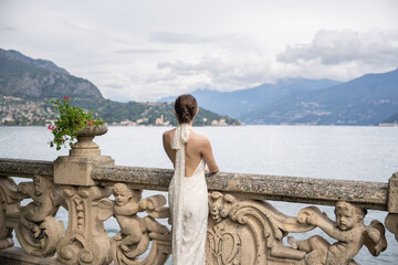 Woman standing on the old terrace balcony at Villa Balbianello. Lake Como, Italy.