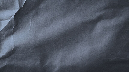 Crumpled dark blue paper texture with soft shadows creates calming atmosphere