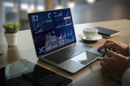 The business analyst used a laptop to analyze financial statistics, creating a digital dashboard for marketing performance reports.