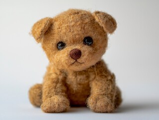 Obraz premium Realistic Hand-Sewn Stuffed Animal Photography Featuring a Cute Brown Puppy Toy on a Minimalist Background