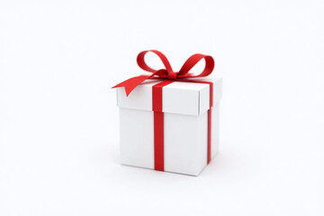 white gift box with a red ribbon tied around it