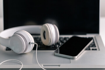 New technology modern Close up high resolution Wireless Earphones white Earbuds headphones black blur background Trendy minimal music device laptop concept phone accessories Comfortable Wooden table