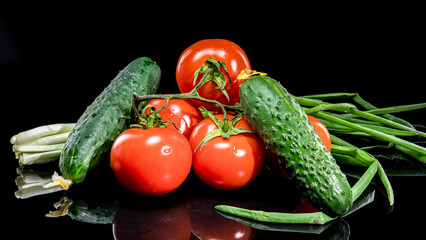 Fresh Tomatoes and Cucumbers on Black Background