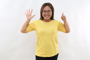 Smiling happy good-looking asian girl giving advice, showing six fingers as explain rules, make...