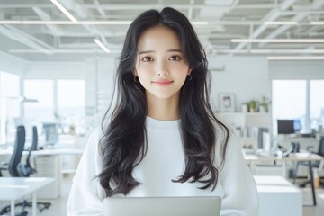 Smiling Asian Businesswoman Working on Laptop in Modern Office