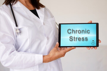 chronic stress. medical concepts. female doctor holding a tablet with words written on it.