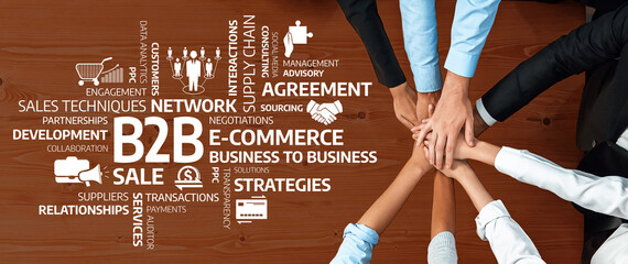 An overhead view of diverse hands in collaboration symbolizes partnership and negotiation in B2B...