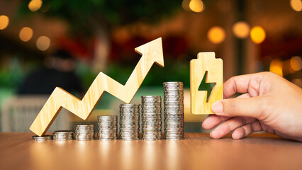 A pile of coins and an electricity symbol, it is a concept of electricity production having higher costs, causing the expenses of the people who have to pay for electricity to increase as well.