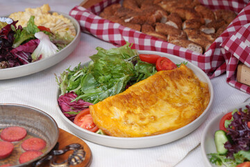Delicious meal featuring fresh salad and omelette with bread