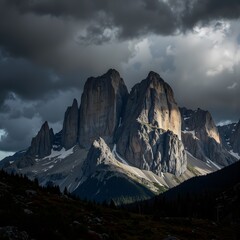 Obraz premium Majestic Mountain Peaks Under Dramatic Storm Clouds Landscape