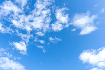 Low angle view and full frame of beautiful blue sky with strange shape of fluffy white clouds in the morning or afternoon in sunny day used as natural background texture in decorative art work