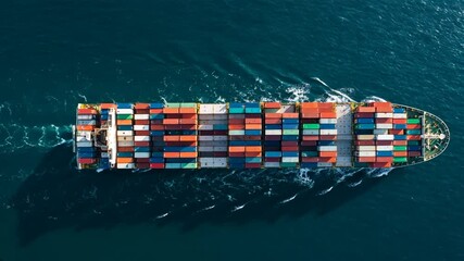 Container ship sails across the open ocean, laden with cargo containers representing global trade