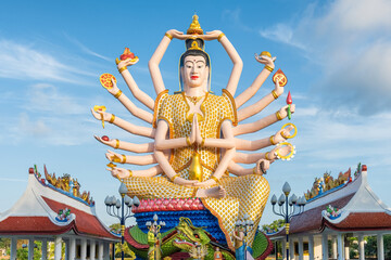 Colorful statue of Guanyin, the Goddess of Mercy and Compassion in East Asian Buddhism with eighteen arms in Wat Plai Laem temple on Koh Samui island in Thailand. Travel and touristic landmark