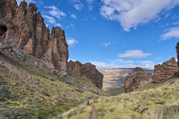The Moon Valley Trail or Valle Lunar in the Patagonia National Park, Chile. A tourist attraction with a landscape beauty -  the old rock formations and diverse colors. A male tourist in the trail.