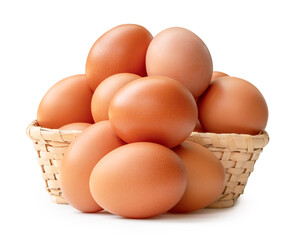 Many raw brown chicken eggs in stack in wicker basket isolated on white background with clipping path