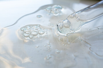 Pipette with essential oil on blurred background