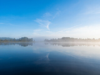 Early morning dawn on a forest lake in the Republic of Karelia in northwestern Russia. Sunrise, fog