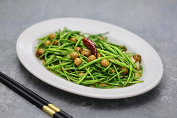 stir-fried white water snowflake stems with pickled cordia dichotoma fruits.