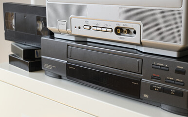 An old TV with a VCR on the table.90s.