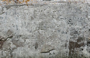 A warm neutral abstract of paint chips on a wall.