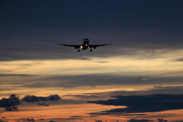 Airliner in a dramatic sky near the sea Phuket airport in Thailand