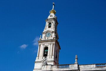 Historic Bell Tower Basilica of Our Lady of the Rosary of Fatima, Portugal Against a Clear Blue Sky