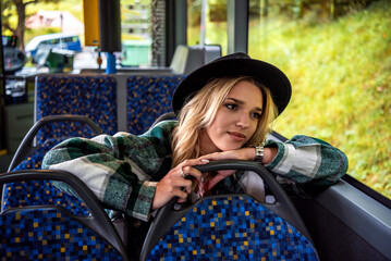 Happy young woman enjoying the window view on a bus ride in Stuttgart, Germany