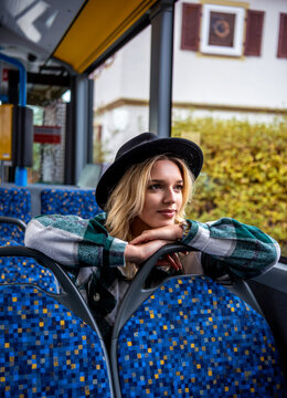 Serene woman enjoying the bus ride through the city of Stuttgart, Germany