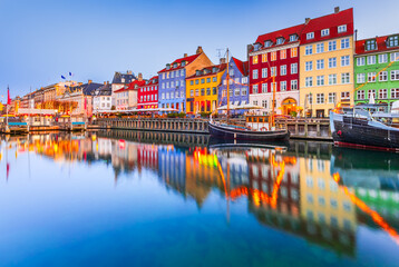 Copenhagen, Denmark. Nyhavn, Kobenhavn's iconic canal, colorful night water reflection.