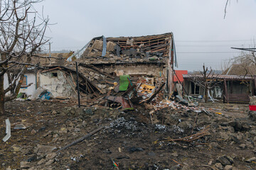 Fototapeta premium Civilian population. Consequences of shelling of a residential building in Ukraine. Destroyed roof, broken windows and traces of an explosion. Details of the destruction of a residential building