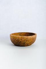 Empty wooden bowl isolated on white background. Side view