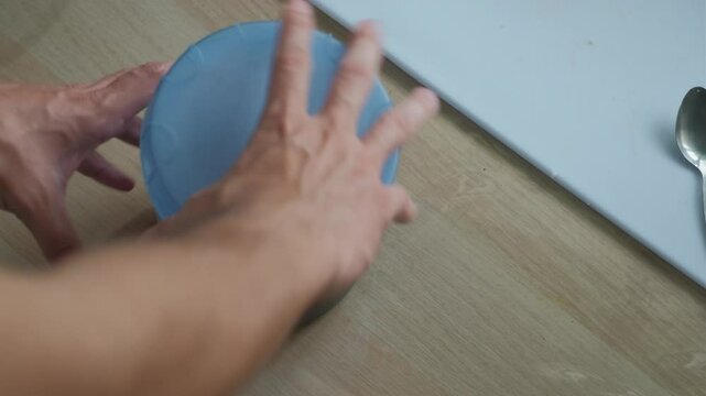 Closing plastic container lid full of soy sauce marinade for storage. -closeup shot