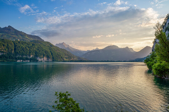 Scenic view of Rautispitz and Baechistock mountains with atmospheric lighting over Lake Walensee in Switzerland.