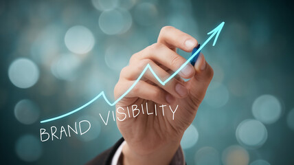 Hand drawing upward brand visibility graph, symbolizing growth and success in business marketing strategy