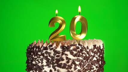 Lighting candles on Chocolate birthday cake on green chroma key background with number twenty golden candles. Celebration Birthday cake for 20 years