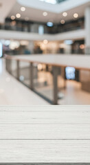 Obraz premium White Wood Tabletop & Blurred Mall Background: Showcase Your Products! Bright, Modern, and Ready for Your Creative Touch.