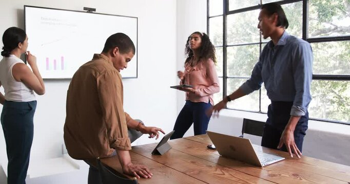 Happy diverse colleagues having meeting, discussing work and clapping hands in office