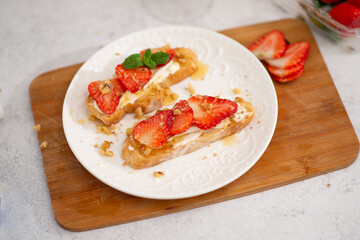 food for a romantic evening. strawberries on bruschetta and champagne