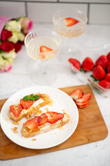 food for a romantic evening. strawberries on bruschetta and champagne
