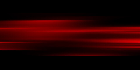 The effect of red light in fast motion on a black background. blurred abstract background with long exposure. neon light
