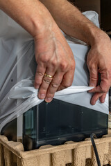 Taking a new coffee machine out of the cardboard box, unpacking a new machine