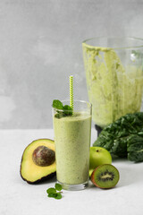Fresh green smoothie with avocado, kiwi and spinach for healthy living and detox diet