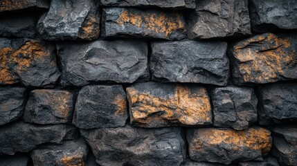 Close-up of a textured stone wall with contrasting dark and rust-colored rocks.